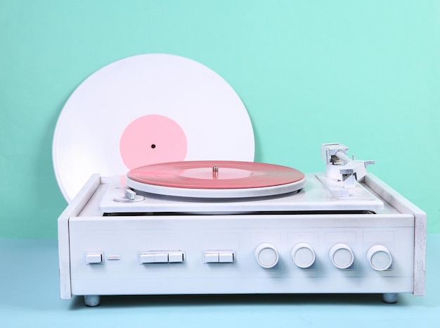 White vinyl record player on blue background DJ equipment Minimalism music concept Creative layout