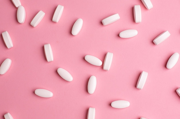 White vitamin pills to raise immunity on pink