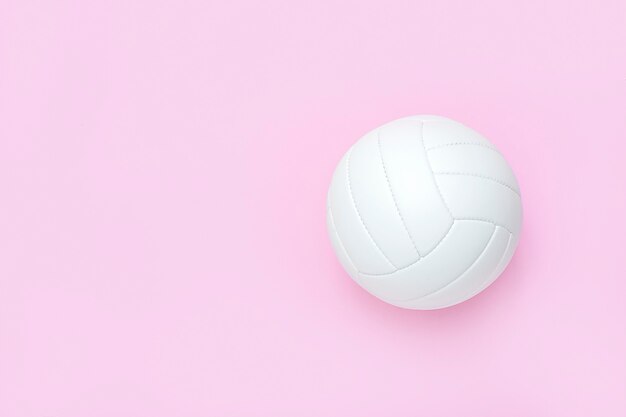 White volleyball leather ball on pink.