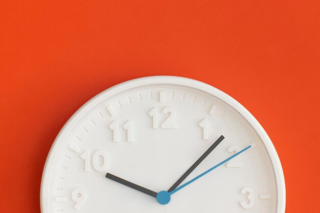 White wall Clock on red background