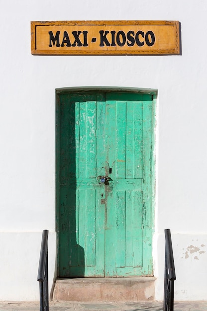 White wall and green old doors in Cachi Argentina