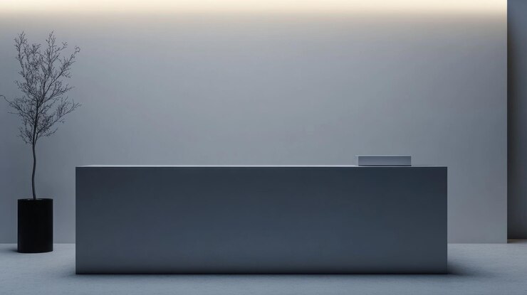 A white wall with a black desk in the middle
