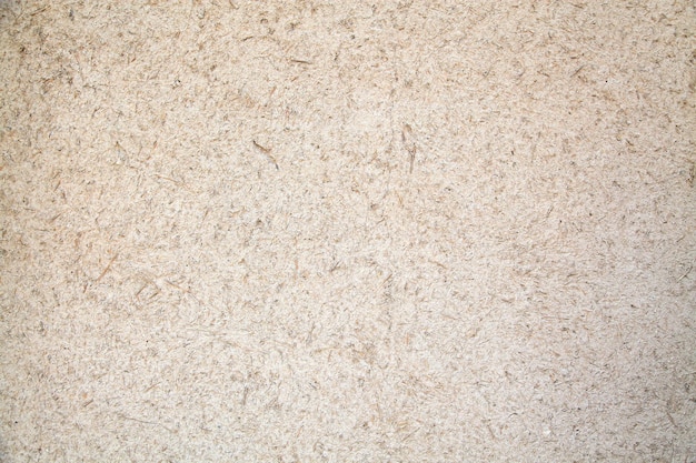 A white wall with a brown speckled texture