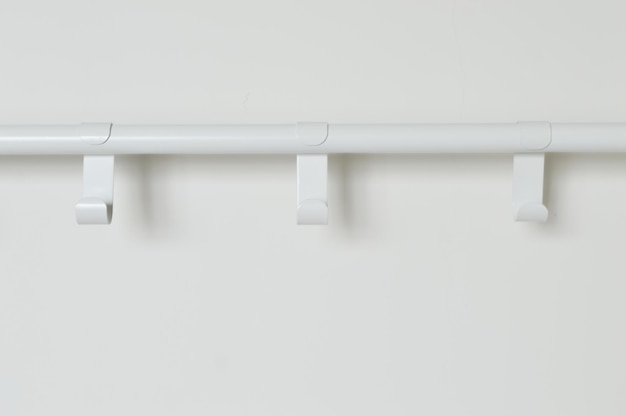 White wall with empty clothes hanger