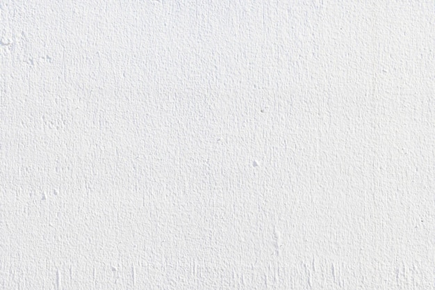 a white wall with a small drop of water on it