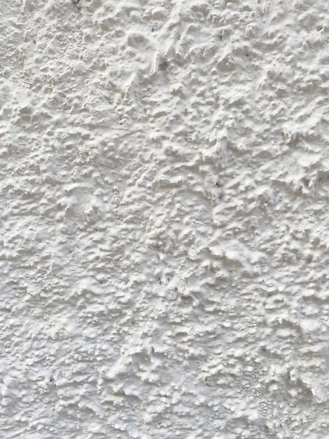 A white wall with a textured surface.