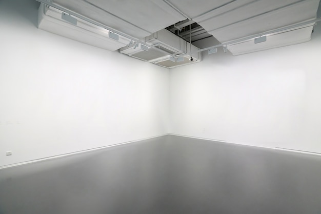 White walls and grey cement floors in the interior space