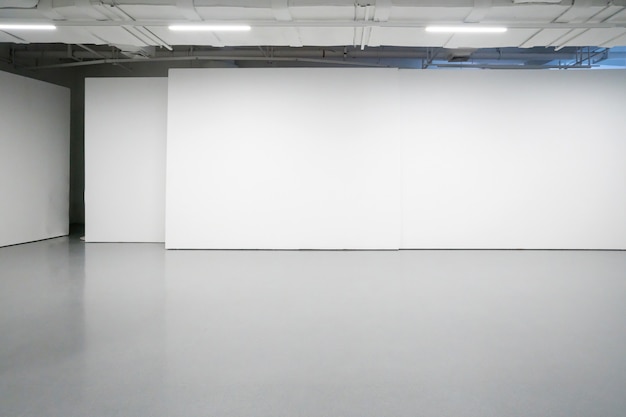 White walls and grey cement floors in the interior space