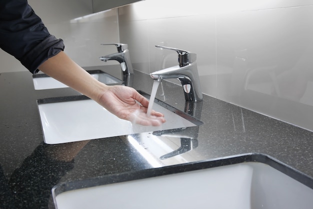 White washbasin and faucet on granite counter with hand washing