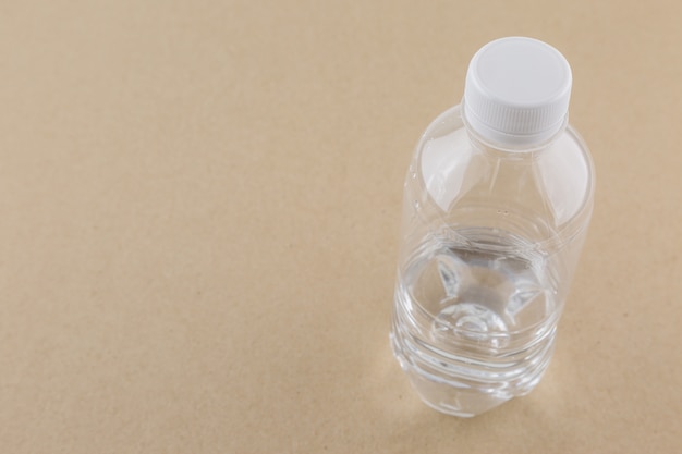 White water bottle on brown paper background