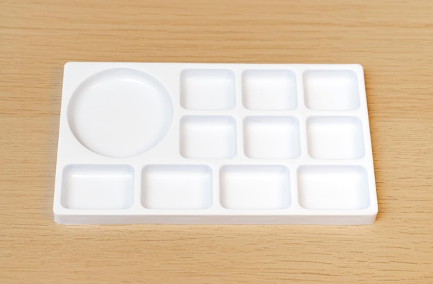 White watercolor palette Empty watercolor tray isolated on wood background White paint palette