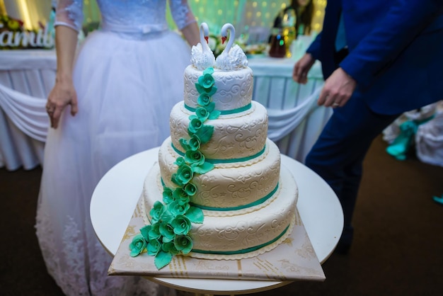 Белый свадебный торт, украшенный цветами и фруктами