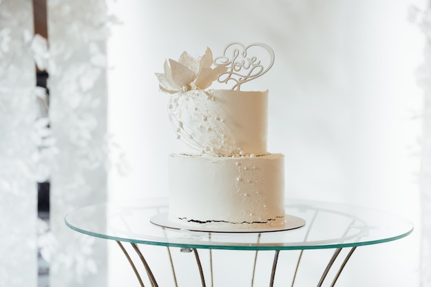 White wedding cake with flowers and blueberries