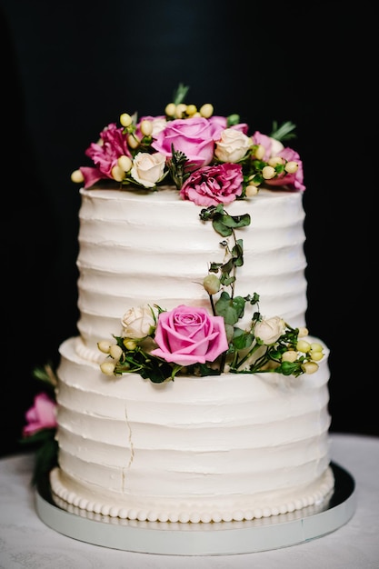 White wedding cake with pink flowers for wedding banquet Delicious wedding reception Copy space Celebration party concept Trendy Cake