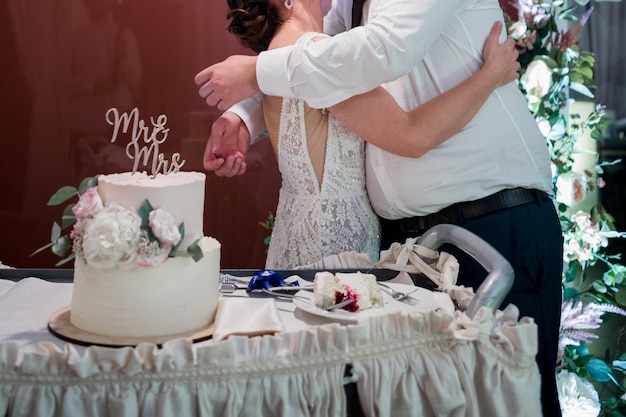 A white wedding cake with the word mrs on it