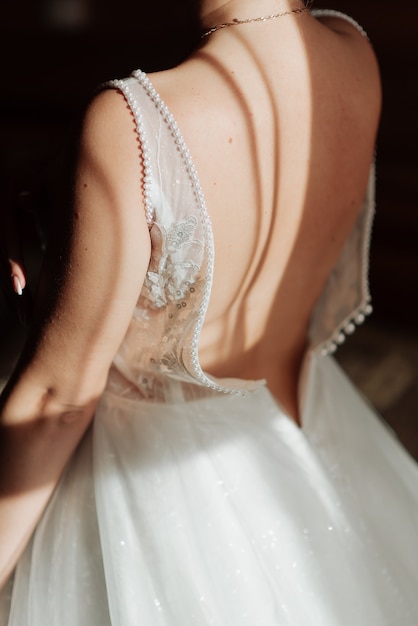 White wedding dress about bare back bride