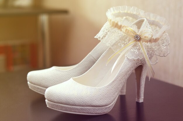 White wedding shoes and the bride's garter