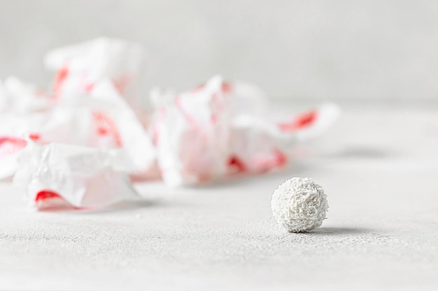 white on white round sweets in coconut flakes