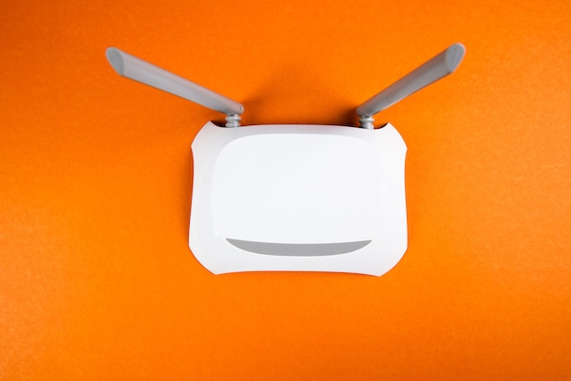 White wi-fi adapter on an orange surface