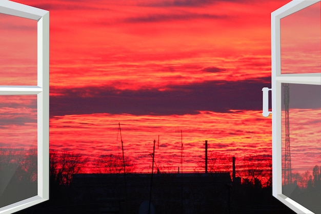 White window opened to the beautiful scarlet sunset