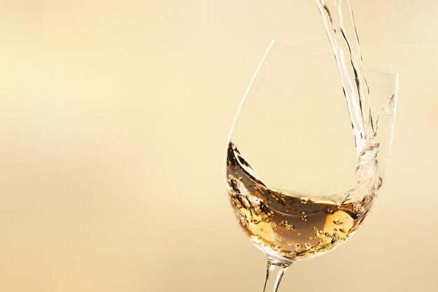 White wine being poured in wineglass