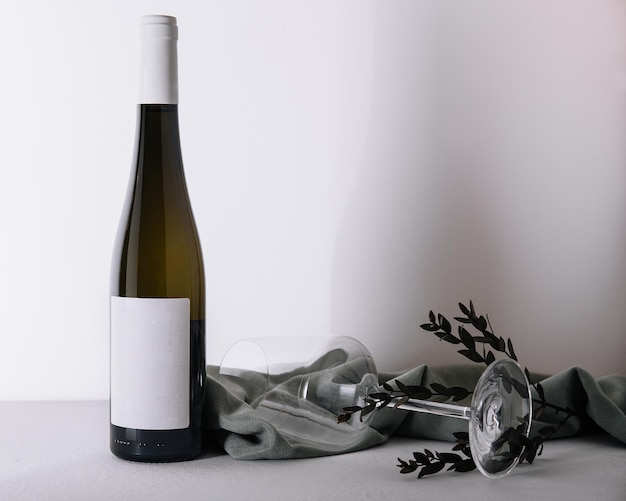 White wine bottle and glass on white