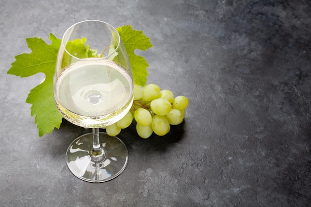 White wine glass and grape