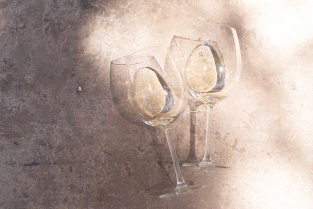 White wine in glasses close up, top view over concrete table