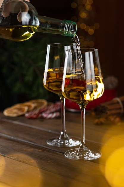 White wine is poured into glasses from a bottle