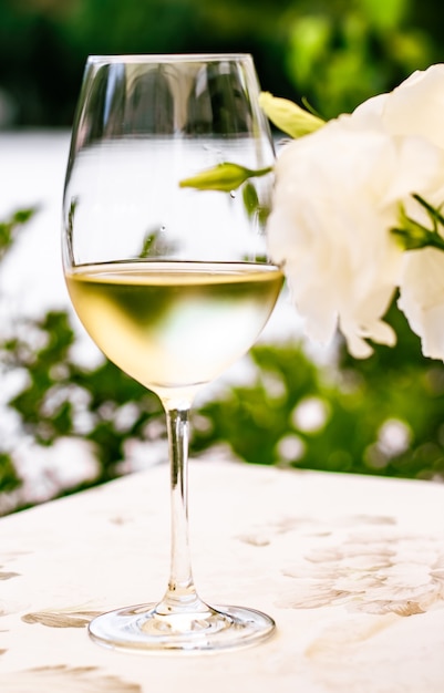 White wine in luxury restaurant on summer garden terrace wine tasting experience at winery in the vi...