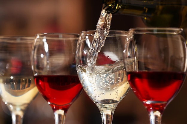 White wine pouring into wine glass closeup