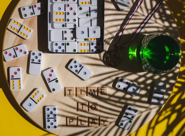 White winner medal green drink and dice time to play on a\
yellow background board game