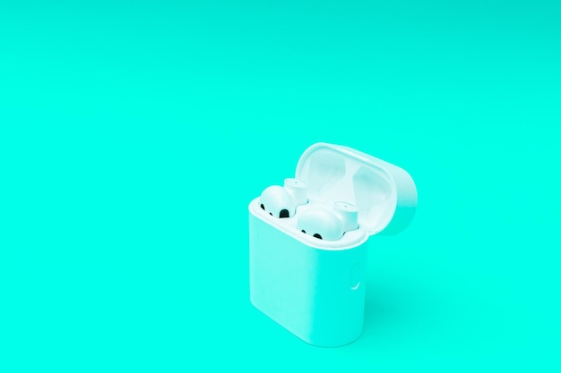 White wireless headphones on neon green background