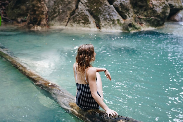 White woman enjoying the waterfall