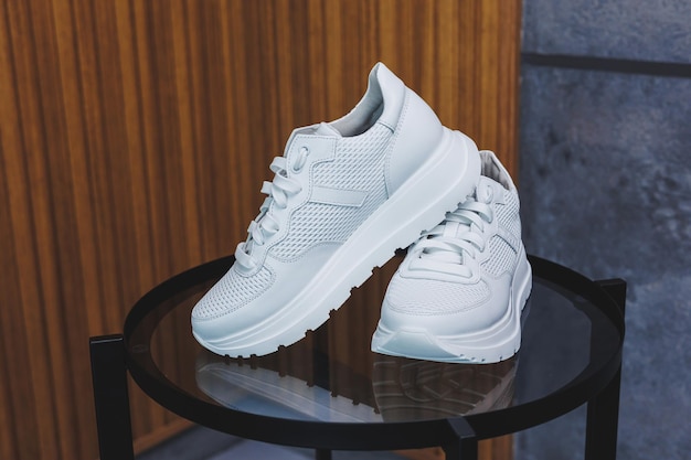 White women's leather sneakers closeup New collection of women's summer leather shoes