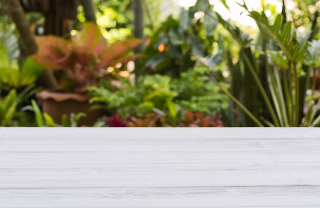 Photo white wood table top with green tree nature background,free space for text or products