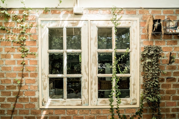 white wood window on brick wall