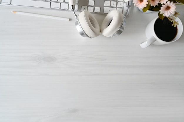 White wood workspace with modern desktop keyboard computer and office accessories