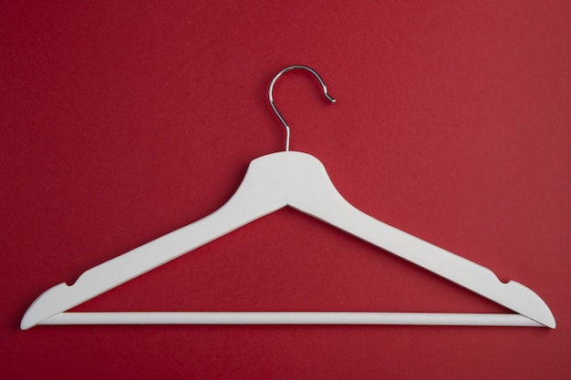 White wooden clother hanger isolated on red background