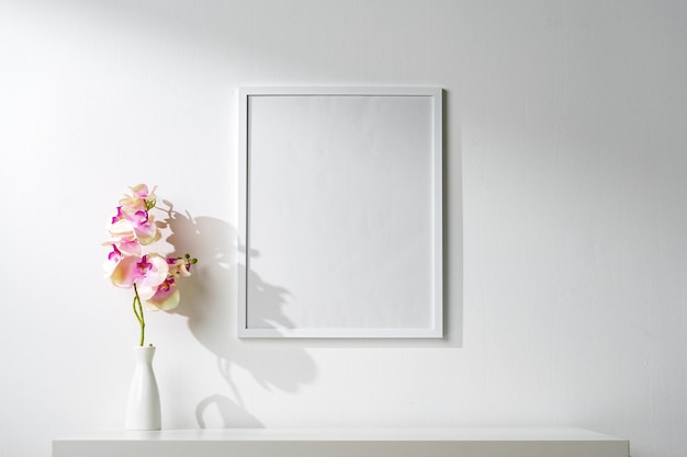 White wooden frame on white wall above the table