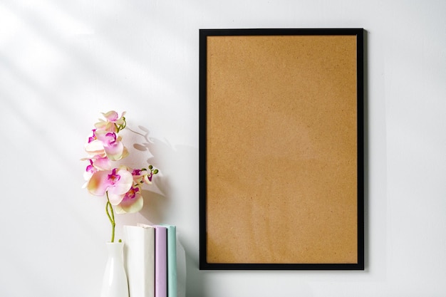 Photo white wooden frame on white wall above the table