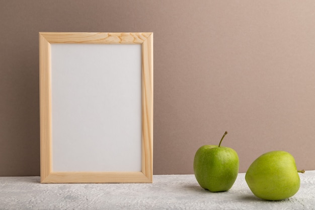 White wooden frame with green apple 