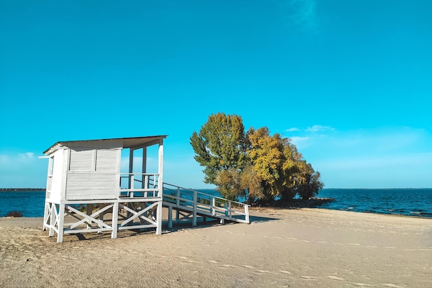 White wooden house for lifeguards on the water at the beach