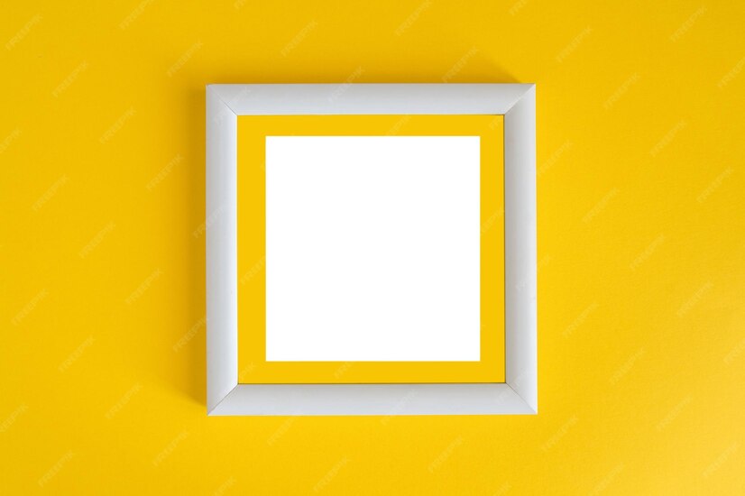 Premium Photo White wooden photo frame on a yellow background. minimalism