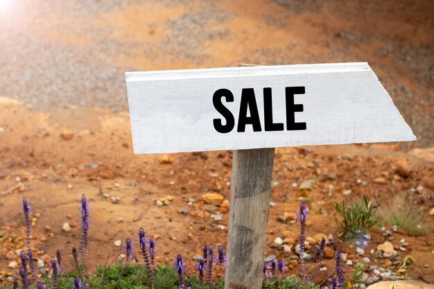 White wooden signpost with the word sale