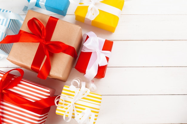 White wooden table with wrapped gifts top view