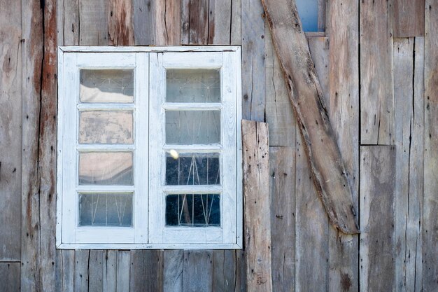 White wooden window on the wall of a vintage wooden house modern design for relaxation in harmony with nature