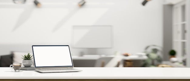 White workspace with open laptop mockup and copy space over blurred modern office background