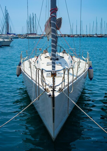 White yacht on a pier tied with a rope