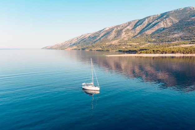 White yacht at sunrise near golden horn beach, island of brac, croatia